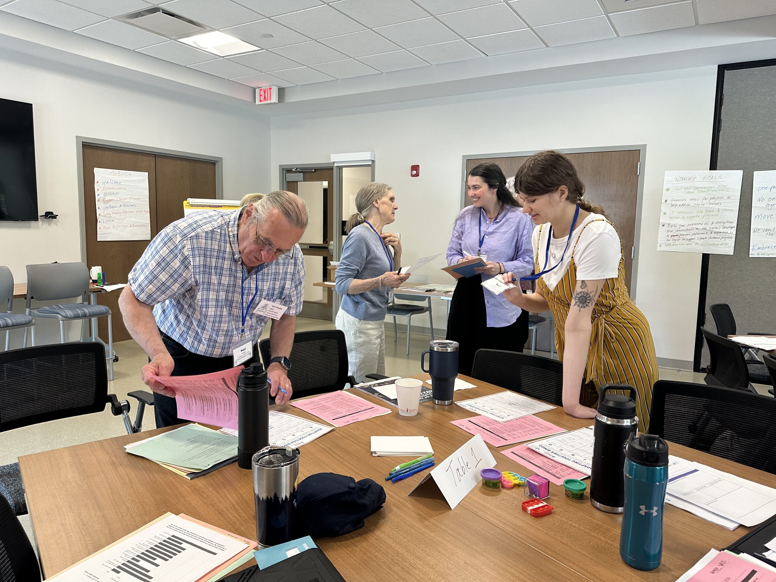 Four people in a room interacting for the Adapting Together Workshop