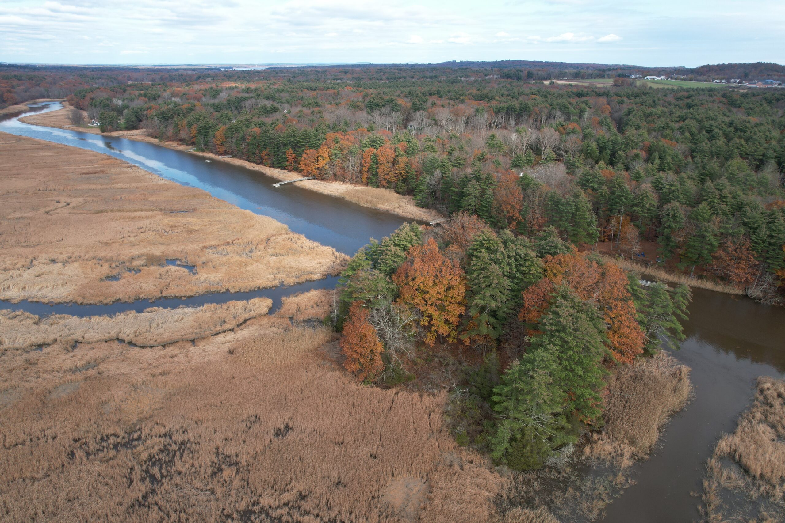 Aerial photograph of the Squamscott River facing towards Stratham in the fall season.